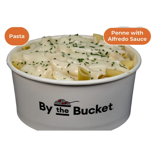 By The Bucket's penne pasta with creamy Alfredo sauce, topped with parsley, in a white bucket.